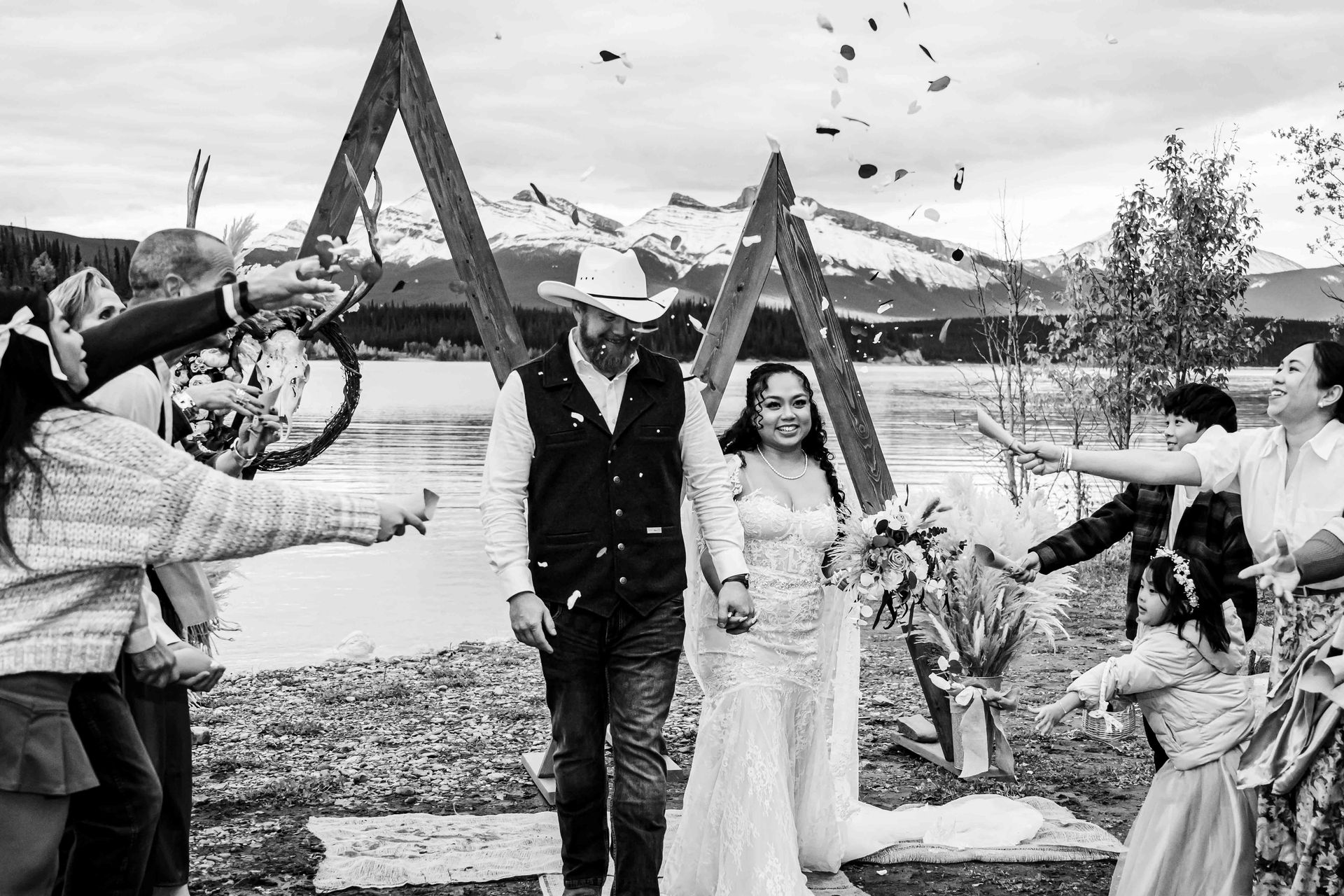 Black and white photo of a couple just married with the setting in the Rocky Mountains in Alberta.