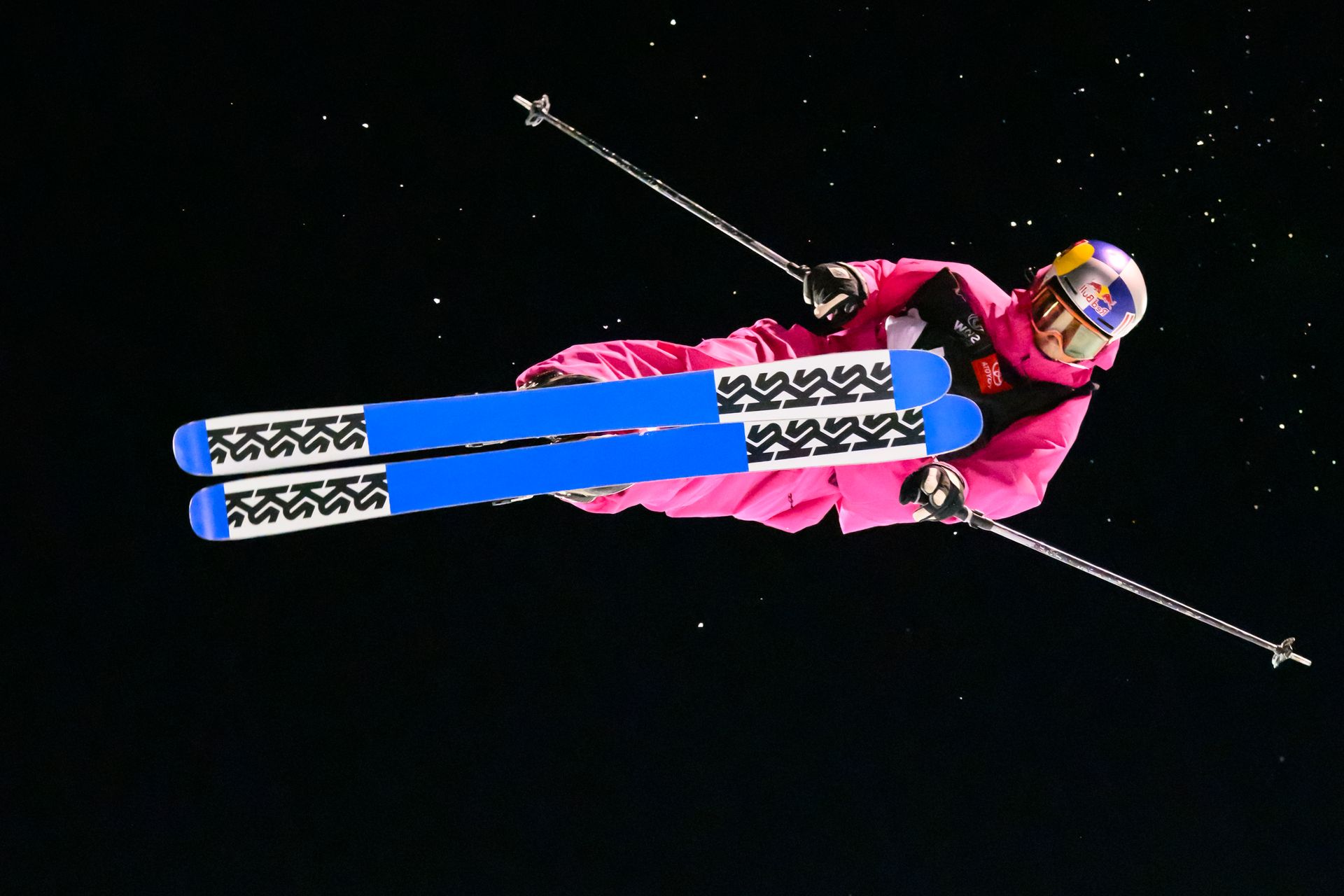 Daring skiier in Half Pipe competition. Skiier is mid air when the photographer captures the image.